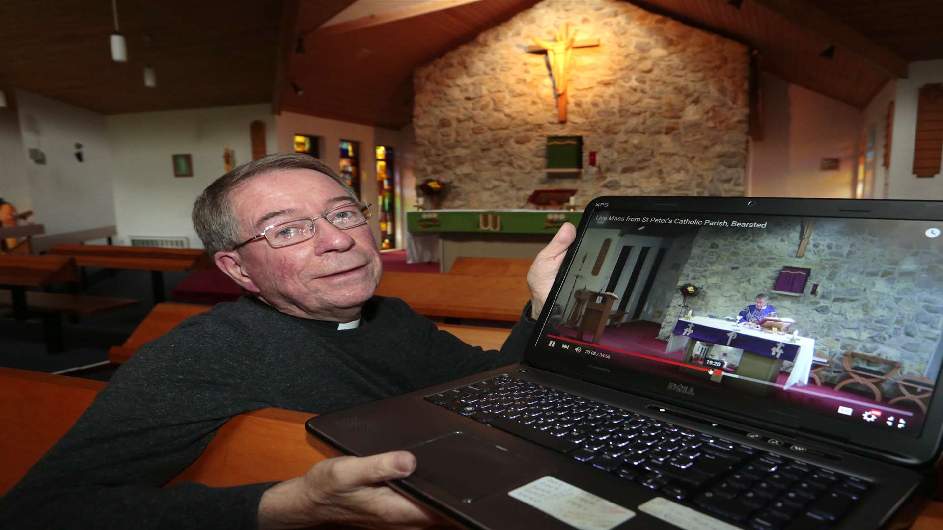 Rev. Fr Geoffrey Pointer with the new Youtube channel the church is launching so it can broadcast services live. Picture: Martin Apps