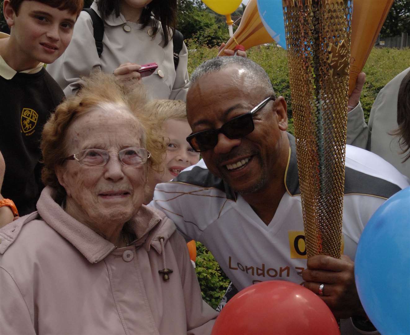 Jean Holton, who turned 90 just weeks later, meets torchbearer George Hamilton. Jean saw the Olympic flame in London in 1948