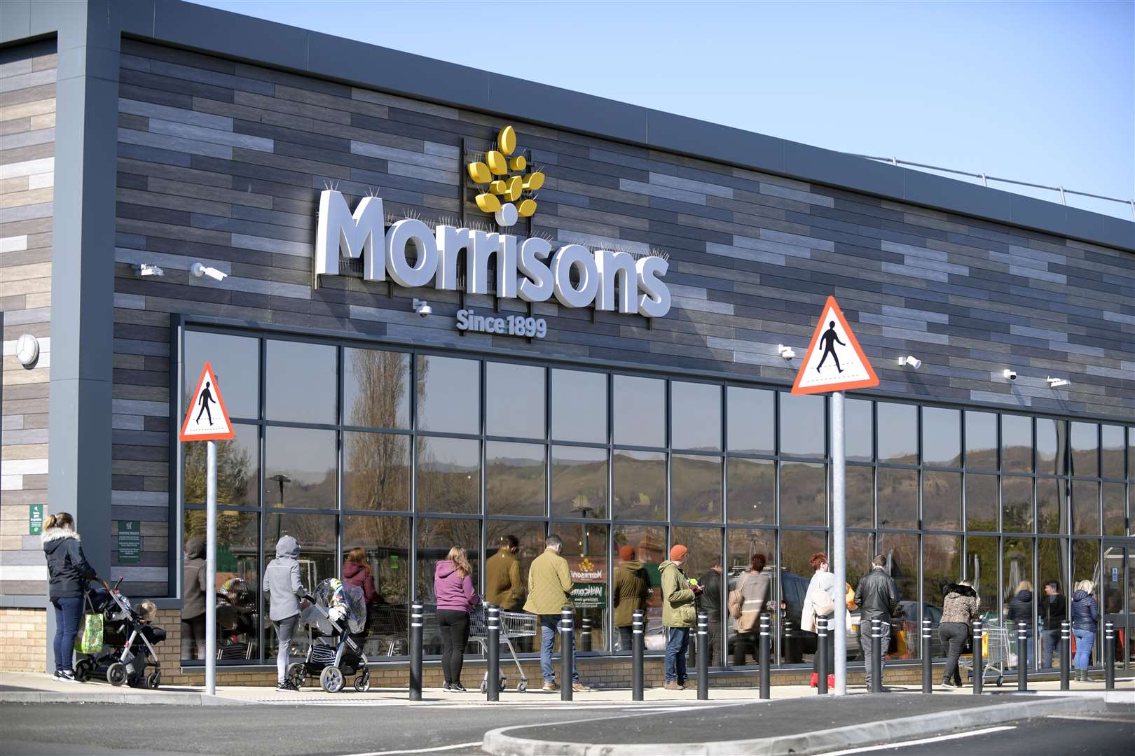 Shoppers awaiting their turn to enter Morrisons supermarket in Folkestone, keeping their safe distance. Picture: Barry Goodwin