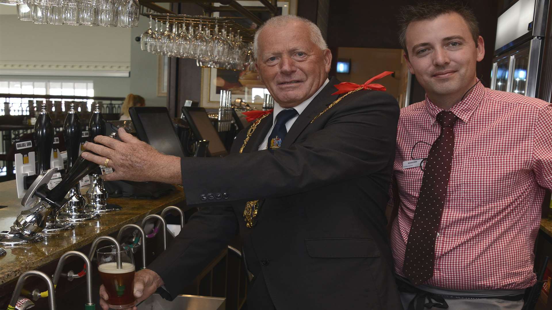 Mayor Cllr Trevor Shonk pulls a pint watched by manager Chris Whitbourn