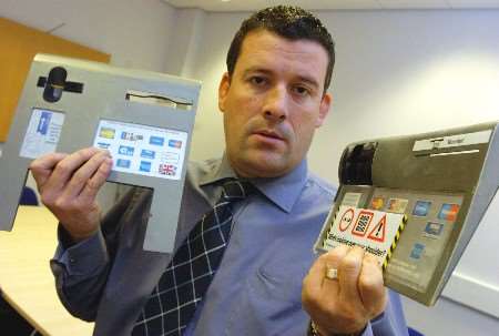 Det Sgt Dave West shows skimming devices used by the fraudsters