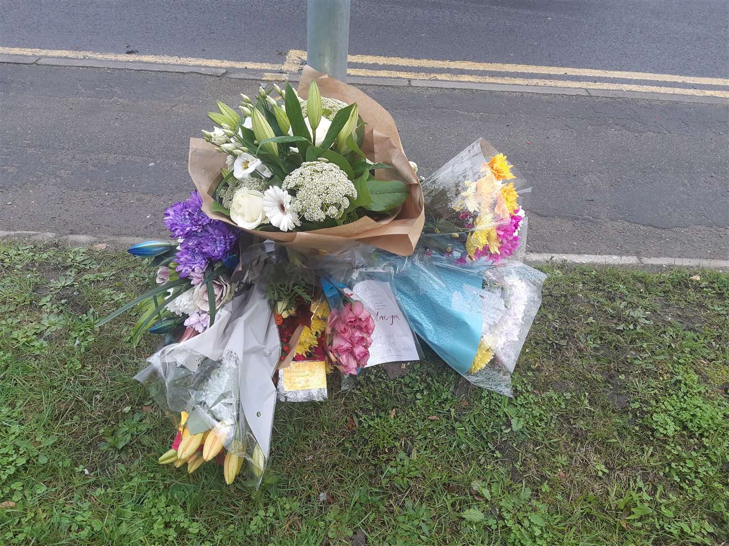 Floral tributes were arranged near the spot of the fatal collision on Medway City Estate