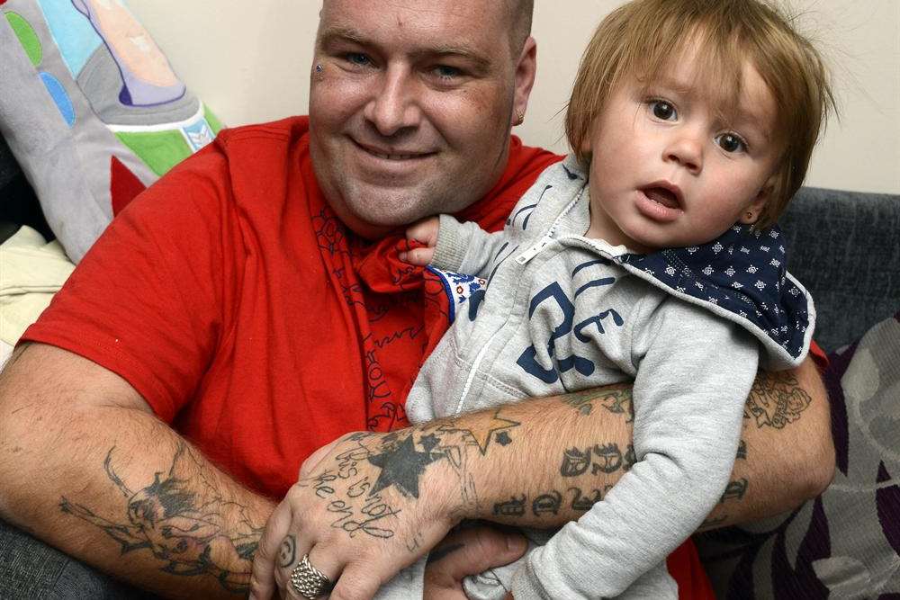 Ashford father Wayne Morton cuddles youngest son Declan, who is turning one