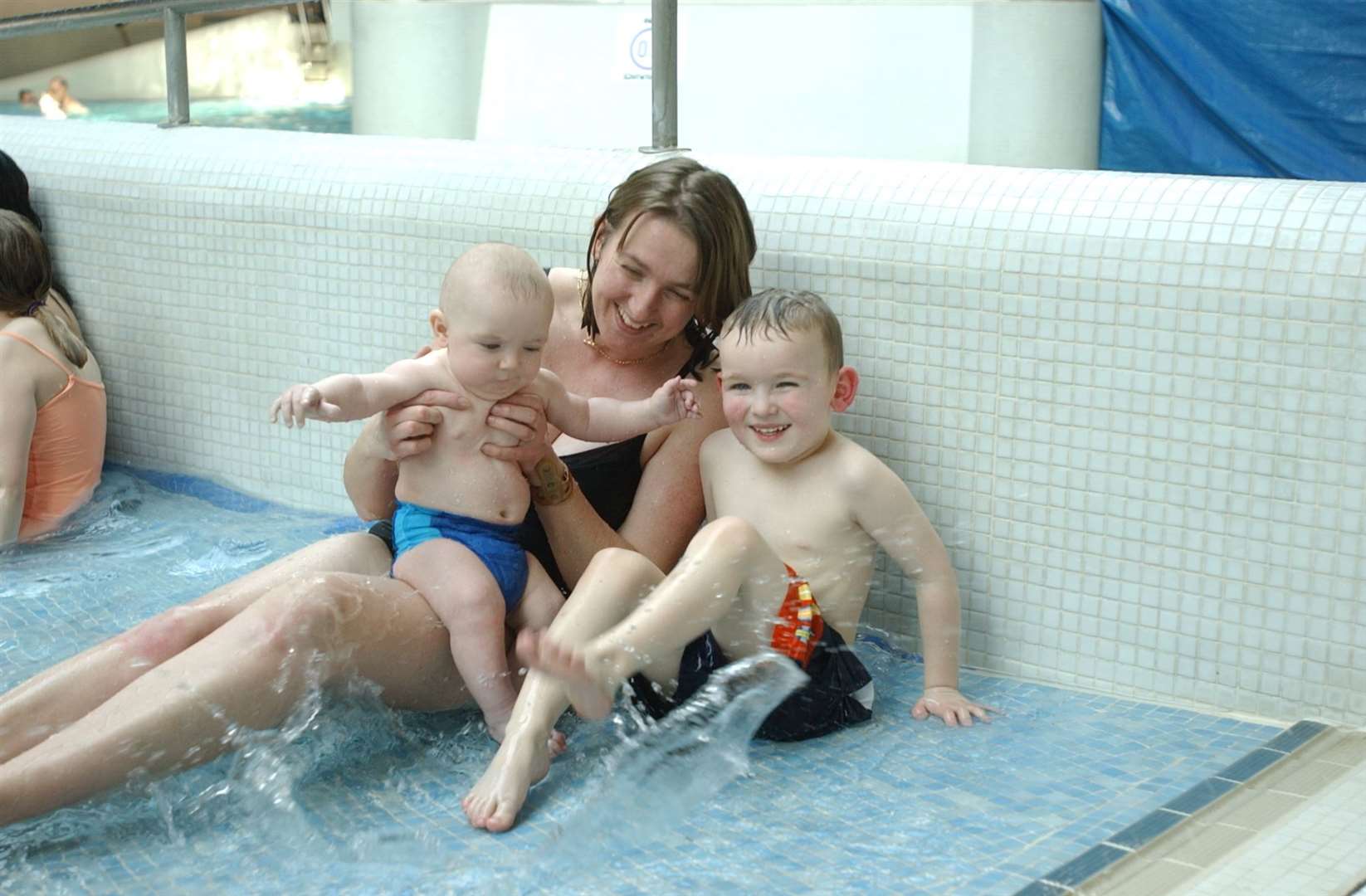 Jackie White with her children Alex 5 months and Adam 4 having a splash when the pool re-opened in 2003