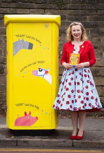 Lydia Monks with the parcel post box in Sheffield which honours her recent book with Julia Donaldson, What The Ladybird Heard (Royal Mail/PA)