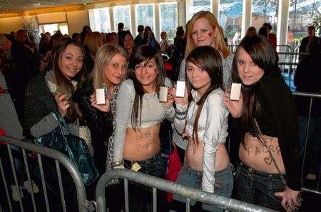 Crowds queue to have Peter Andre sign bottles of his new perfume.