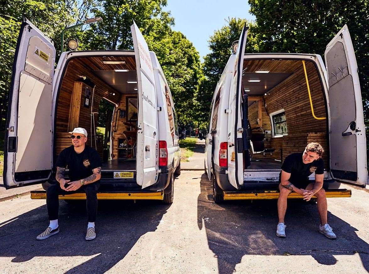Aaron Simmons (left) and Danny O'Neill (right) sitting at the back of their Busking Barber vans. Picture: Paul Astley