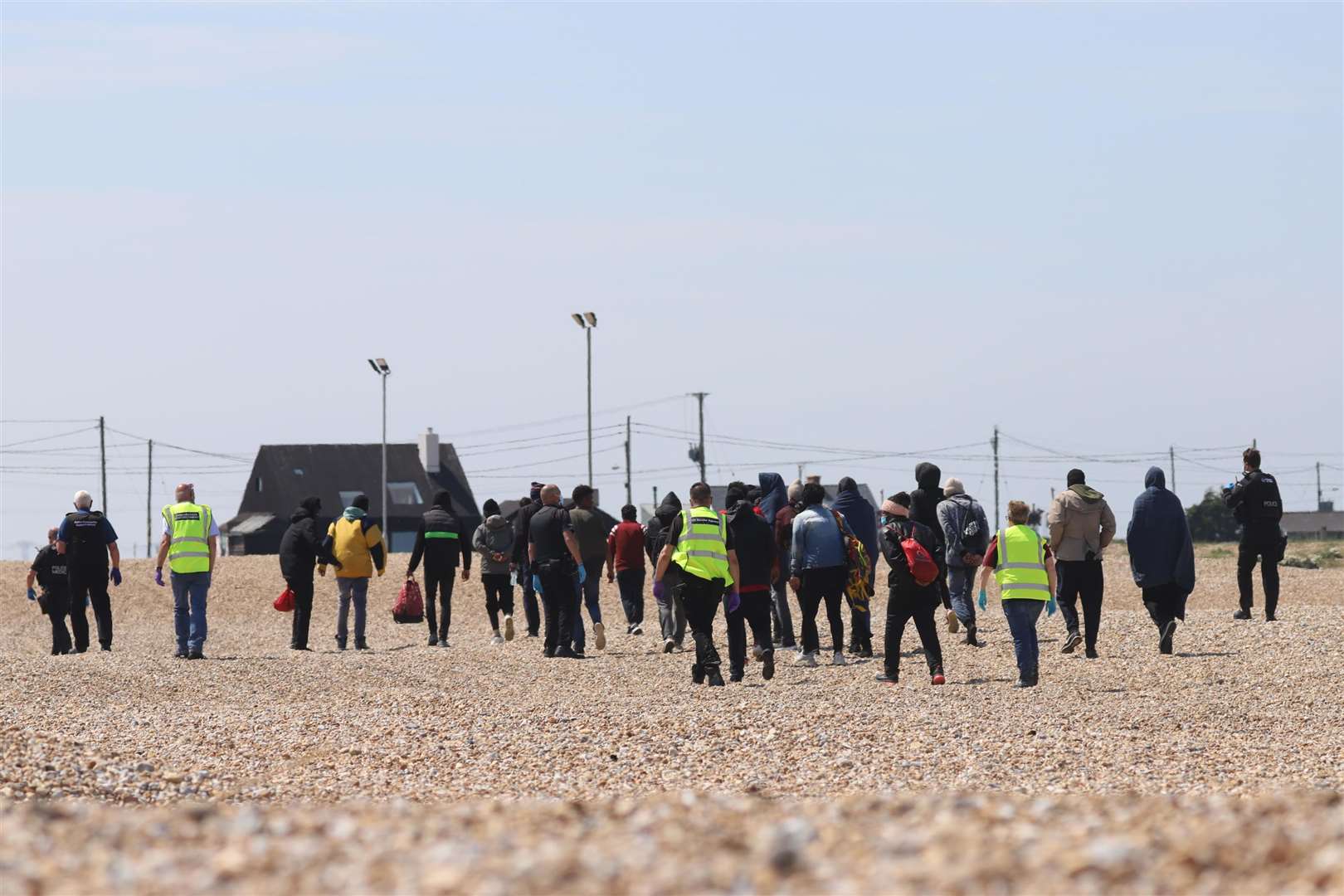 Asylum seekers with British police and officials at Dungeness yesterday. Submitted picture