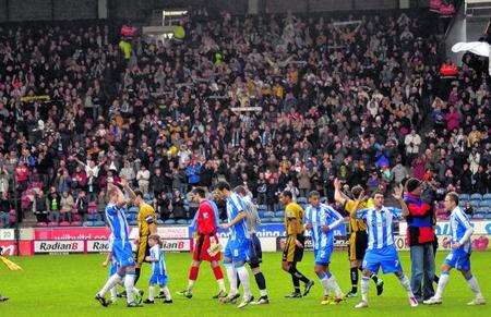 Dover's fans applaud their side at the end of the 2-0 defeat at Huddersfield in the FA Cup Third Round