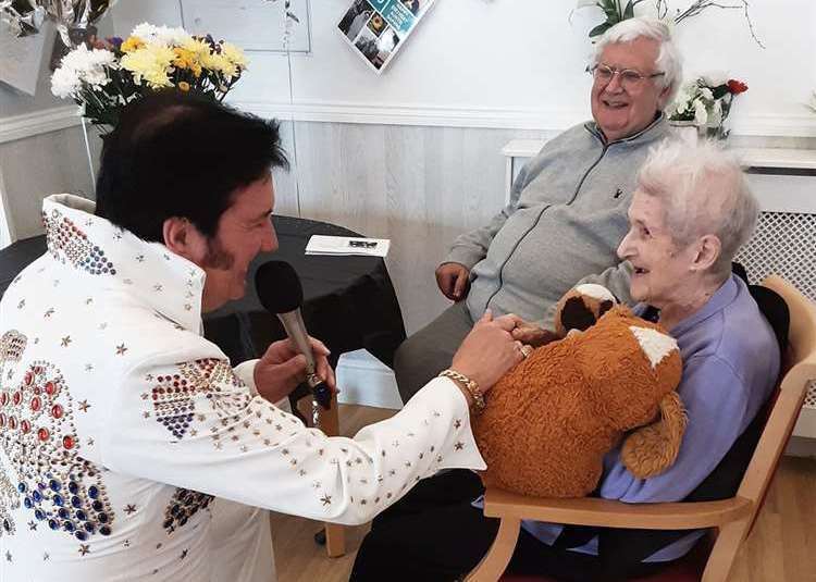 Ms Hikin enjoying a performance from an Elvis Presley tribute act who serenaded her with her favourite songs (Woodstock Residential Care Centre/PA)