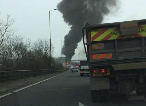 A plume of smoke rises from the vehicle