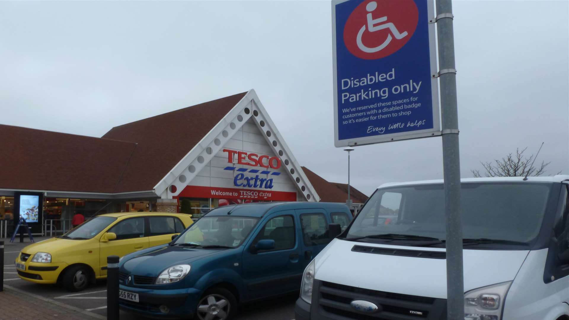 A white van parked in a disabled bay without displaying a blue badge