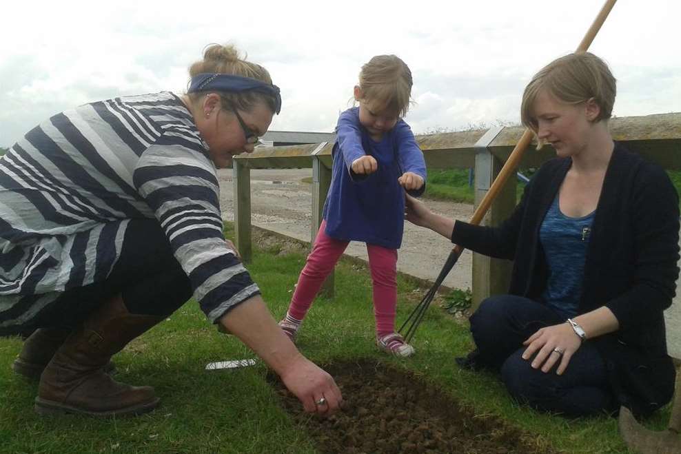 Mandy Shade planting poppy seeds with Anna Kenten and her daughter Sophia