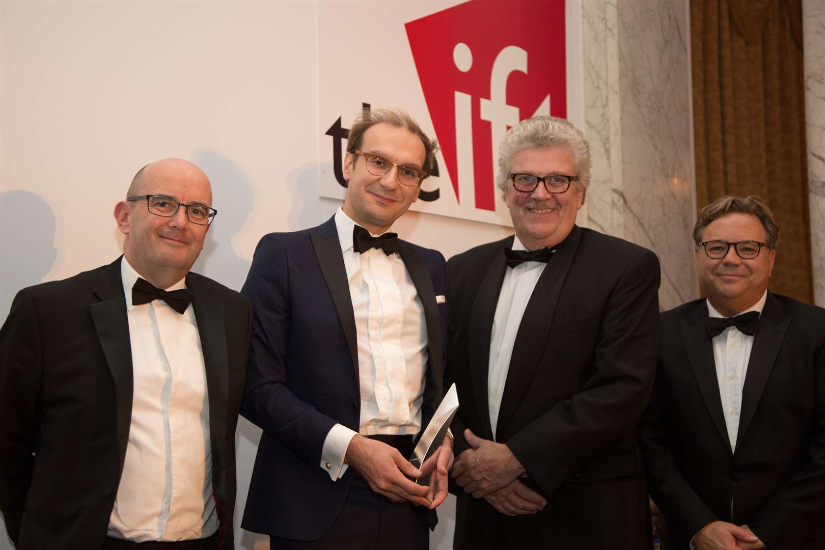 With the award, from left, Adam Loviett of Insolvency Risk Services, Mark Lumsdon-Taylor of the Hadlow Group, Mark Dance of Kent County Council and Graham Rusling from The Institute of Fiscal Turnaround