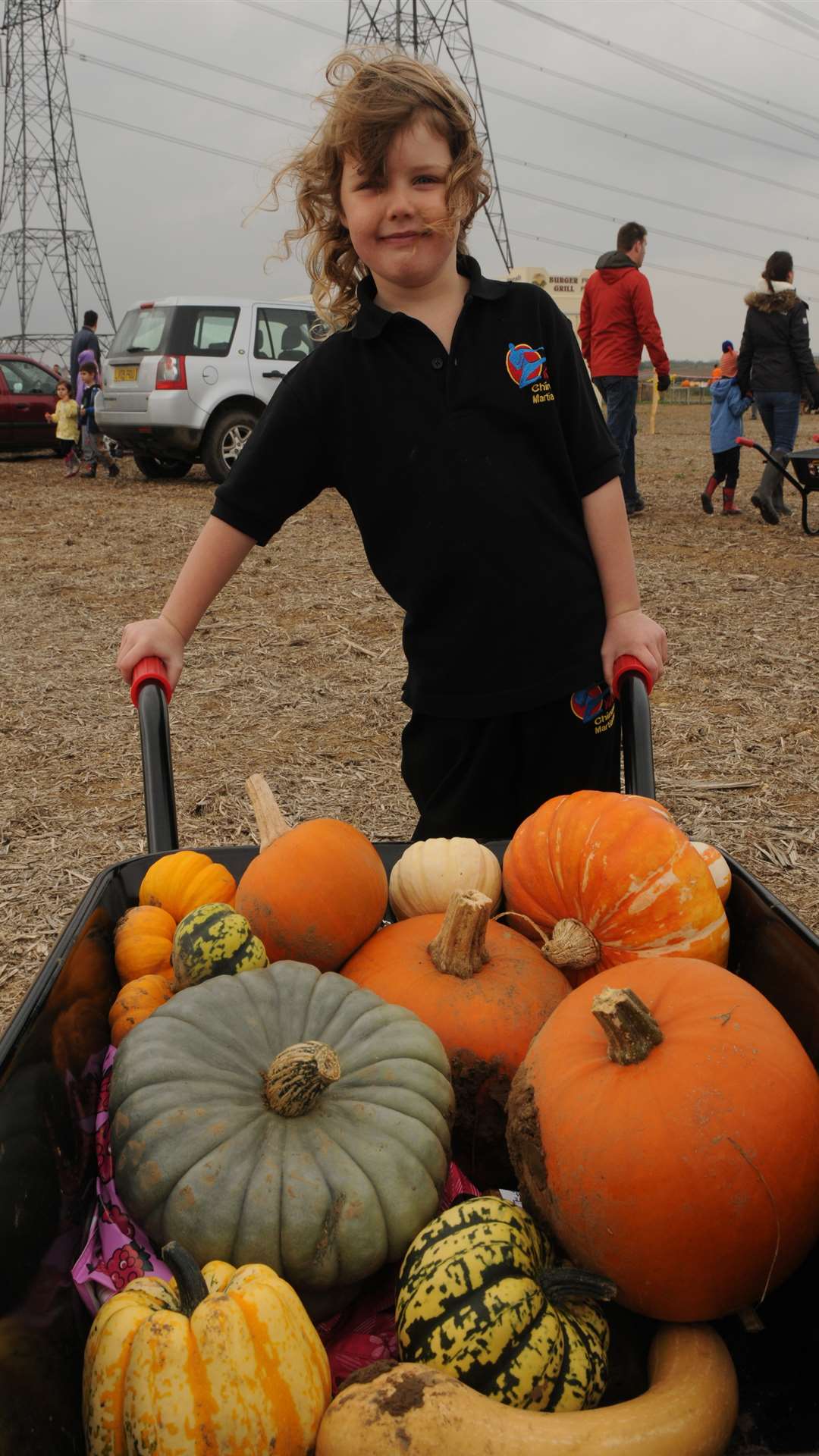 Paige Ellingworth with a wheelbarrow of pumpkins from Beluncle Farm, Stoke Road, Hoo