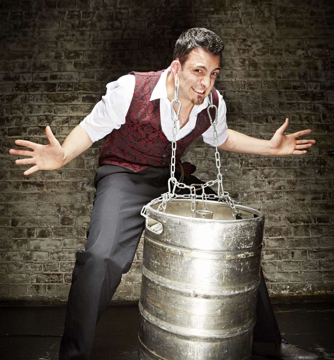 Johnny Strange from Dartford carrying a barrel using his ears. Photo: Paul Michael Hughes/ Guinness World Records