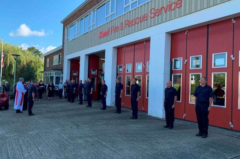 Firefighters stand to attention outside the Maidstone Fire Station in honour of their departed colleague Malcolm Farrow