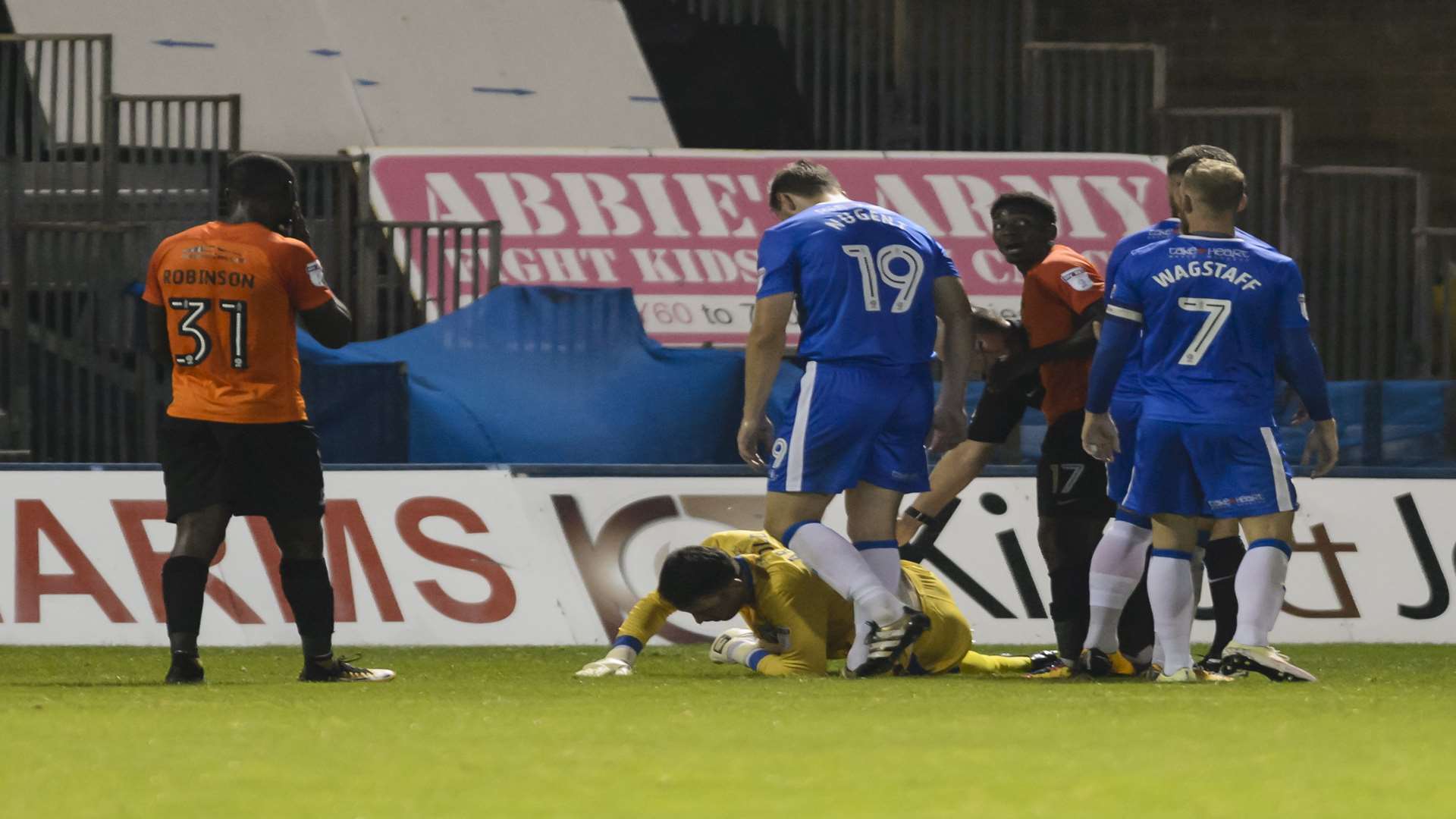Gills keeper Steve Arnold goes down after a challenge from Jermaine McGlashan Picture: Andy Payton