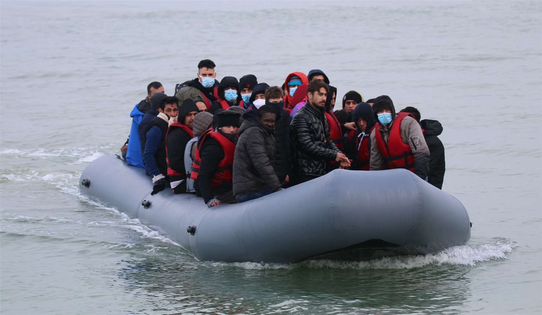 Asylum seekers landing on the beach in Kent. Stock picture