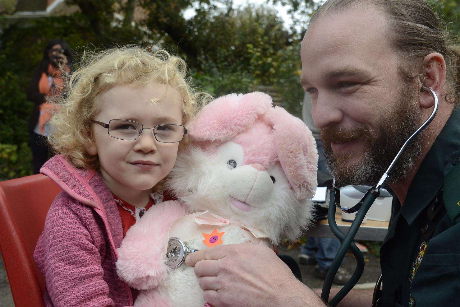 Gracie Butcher, three, waits anxiously as Rabbit is checked over by emergency medical technician Dan Beardsmotre