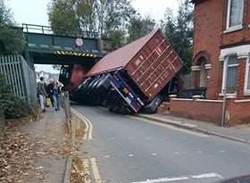 The lorry was left on its side after striking the bridge. Picture: Michael Taylor
