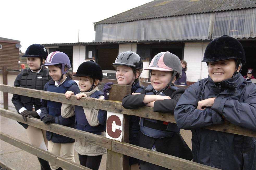 Riders watch their fellows in action at the Whiteaf Stables, Teynham
