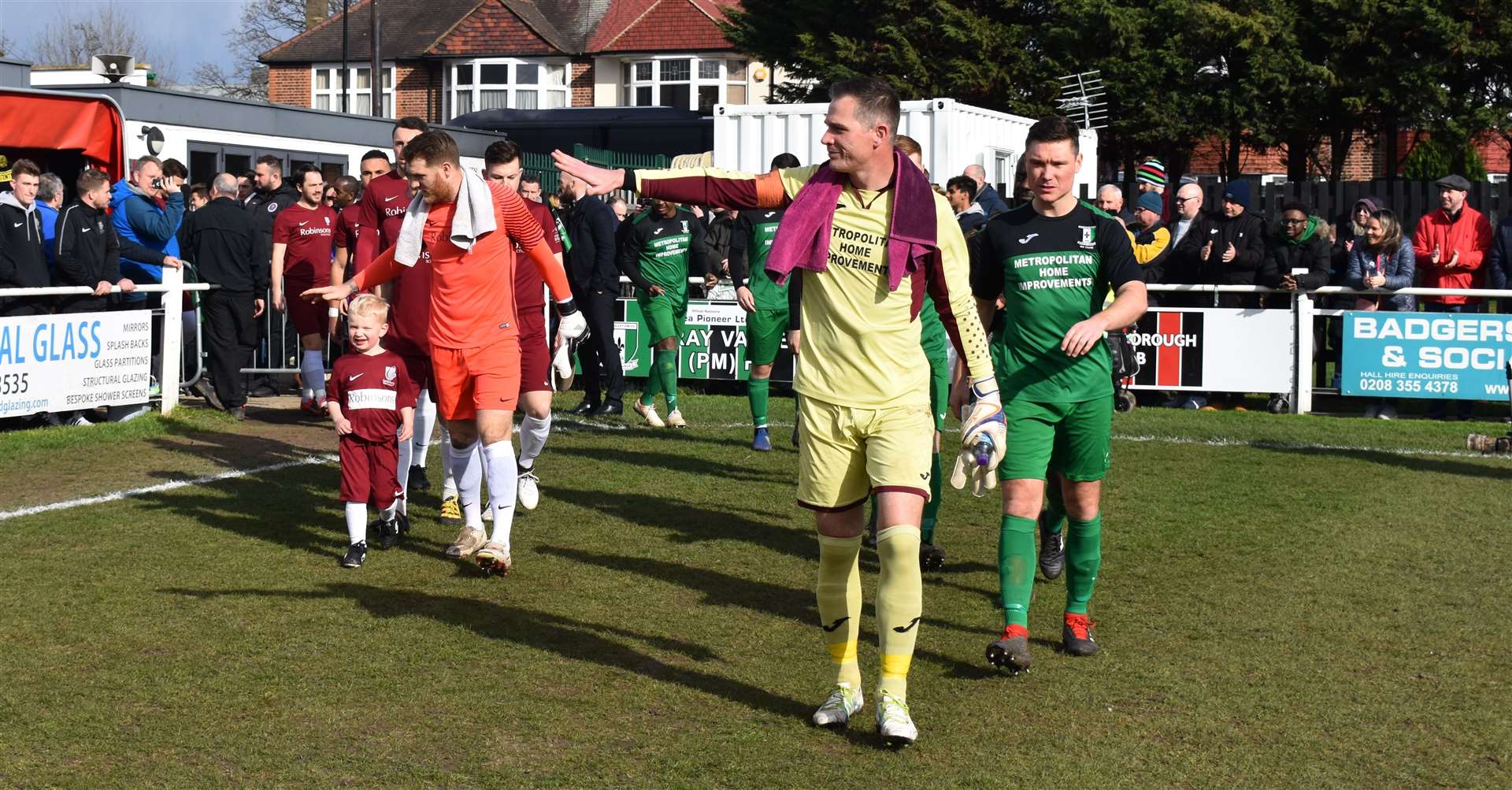 Jack Delo and Andy Walker lead the teams out Picture: Alan Coomes
