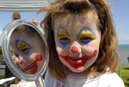 Reflecting on her face painting, Zoe Lewis, six, at the Whitstable Umbrella Centre fun day