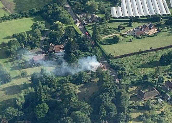 An aerial view as smoke pours out of the property in Sutton Valence. Picture: Oliver Holmes