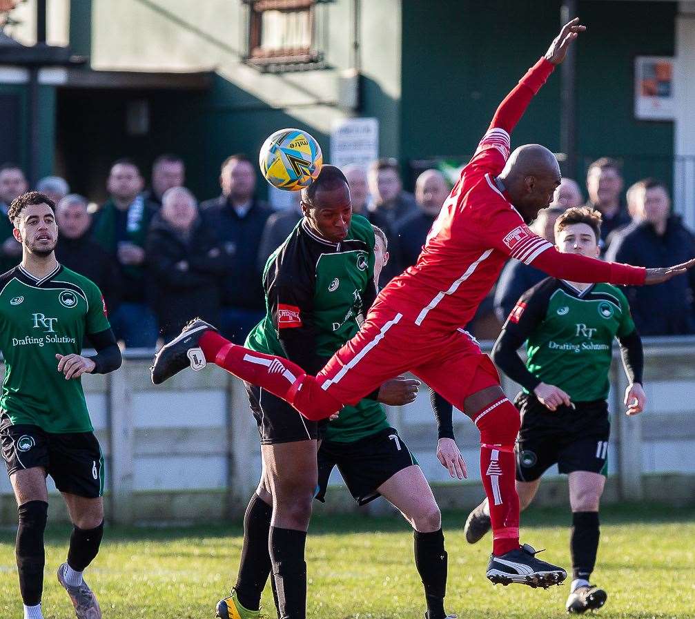Toib Adeyemi beats returning Whitstable defender Junior Baker to the ball. Picture: Les Biggs