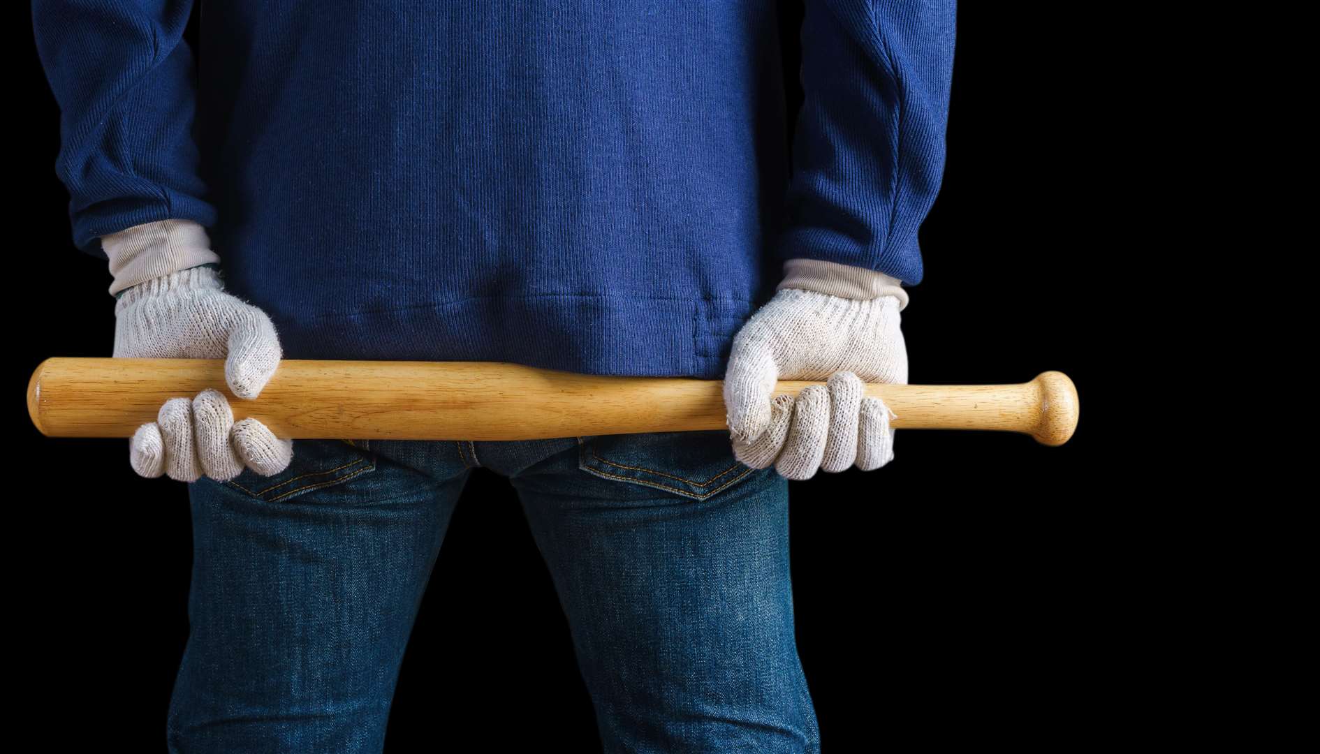 The man allegedly pressed a baseball bat up to the woman. Stock Picture