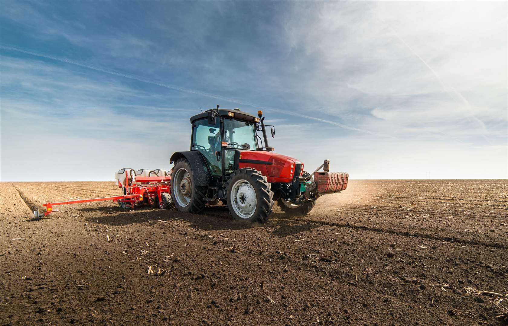 Farmer seeding crops at field. Stock picture