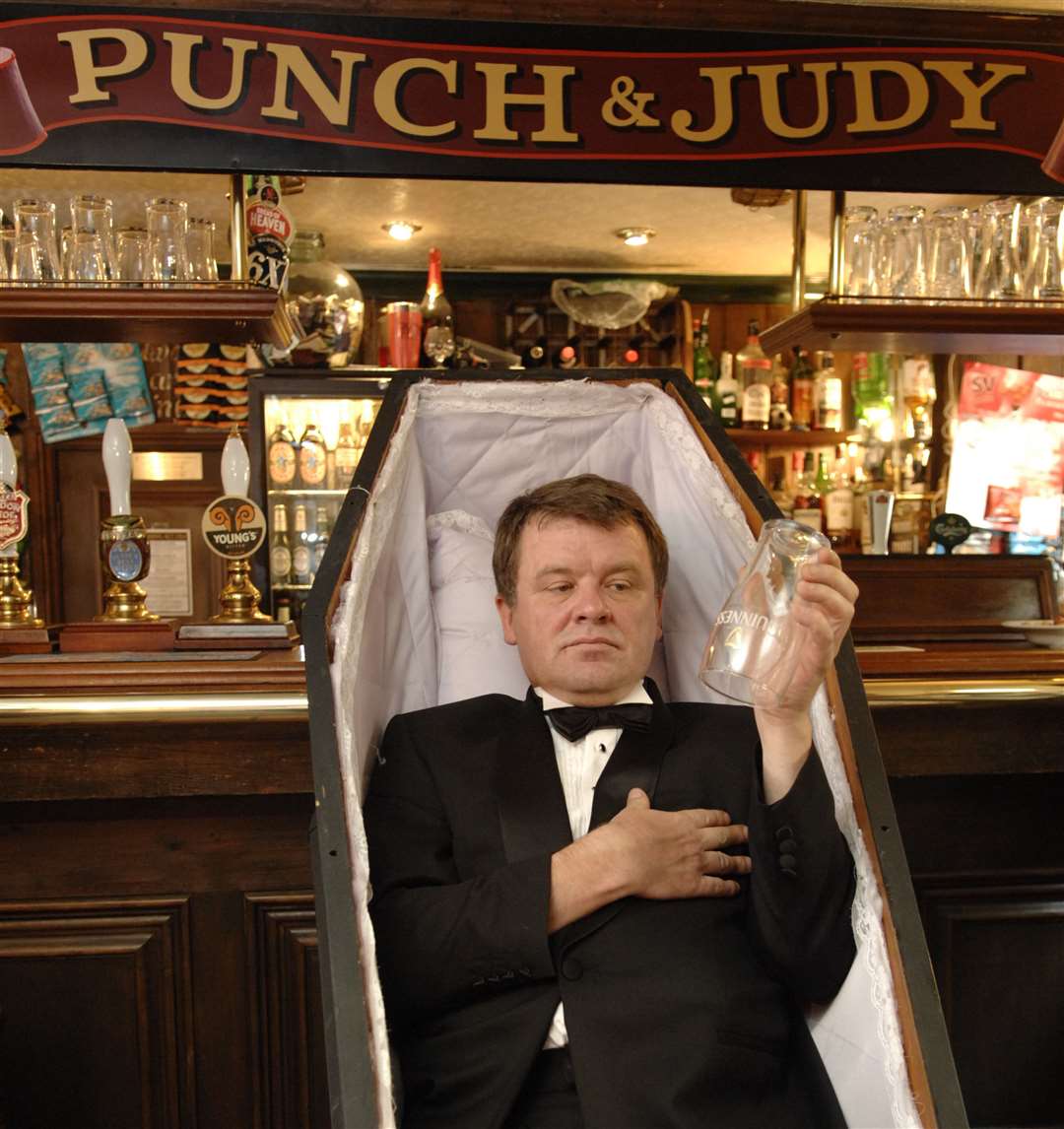 The landlord of the Punch and Judy in St Stephens Street, Tonbridge, lies in a coffin in September 2008 as part of his protest at the death of the British pub trade. The pub is still going today. Picture: Matthew Walker