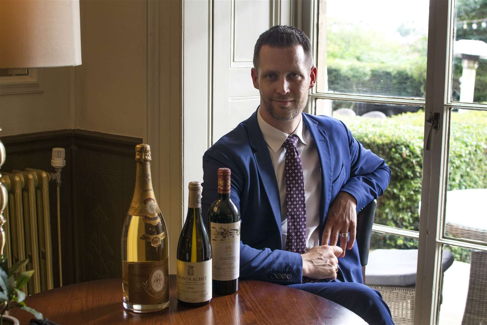 Hotel du Vin general manager James McComas and the three bottles of wine in the silent auction