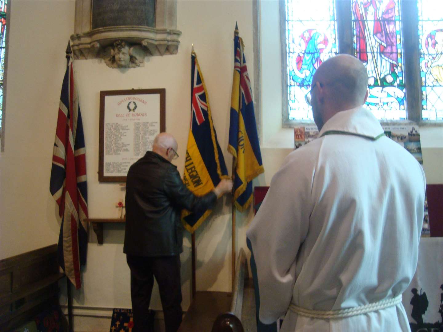 PCC member Peter Lurcock places the standard in its new home, watched by the vicar Ron Tugwell