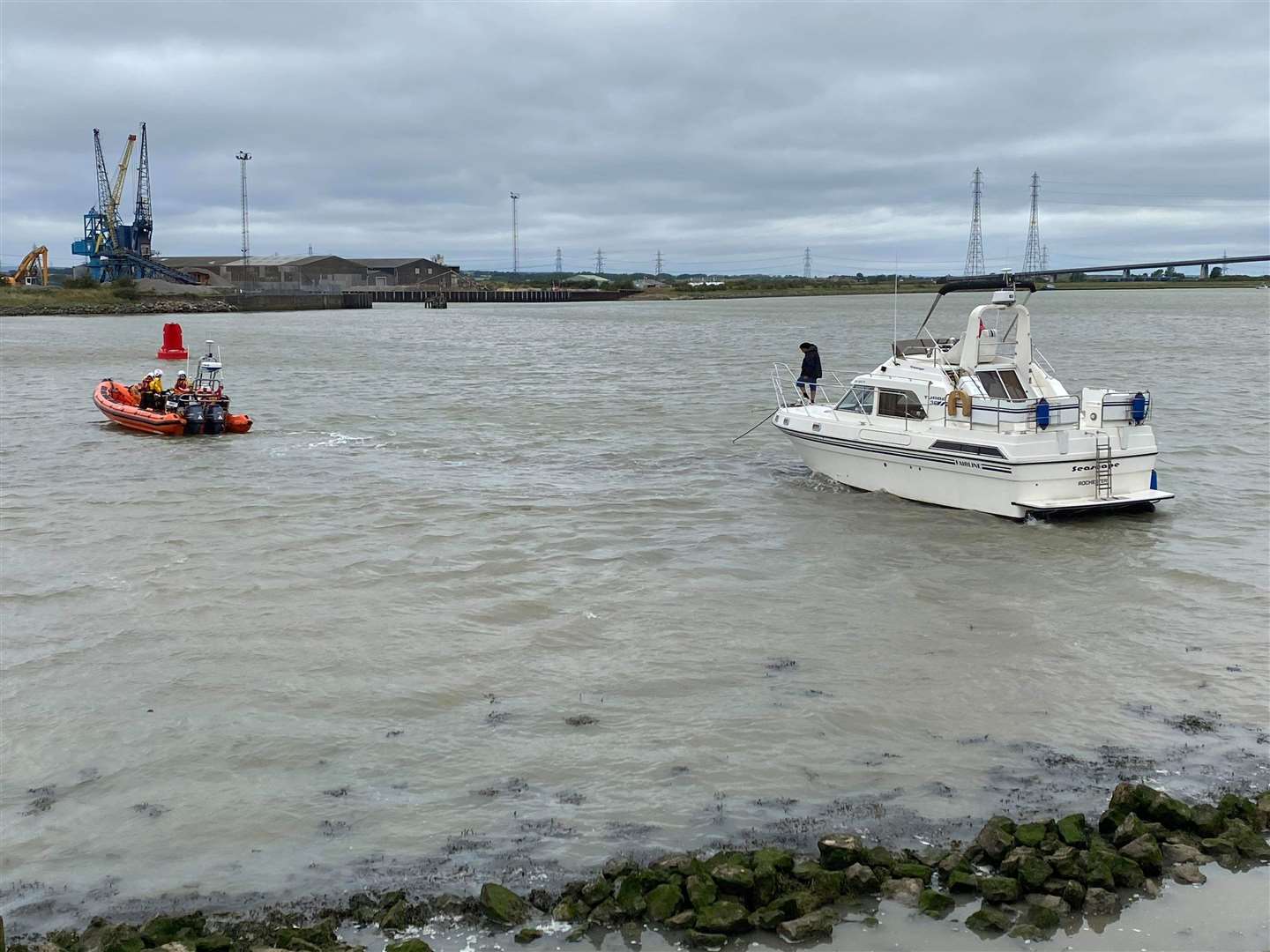Whitstable lifeboat tows the stricken cabin cruiser back into open water near the Kingsferry Bridge on Sheppey on Saturday morning. Picture: James Crane/Sheppey Coastguard