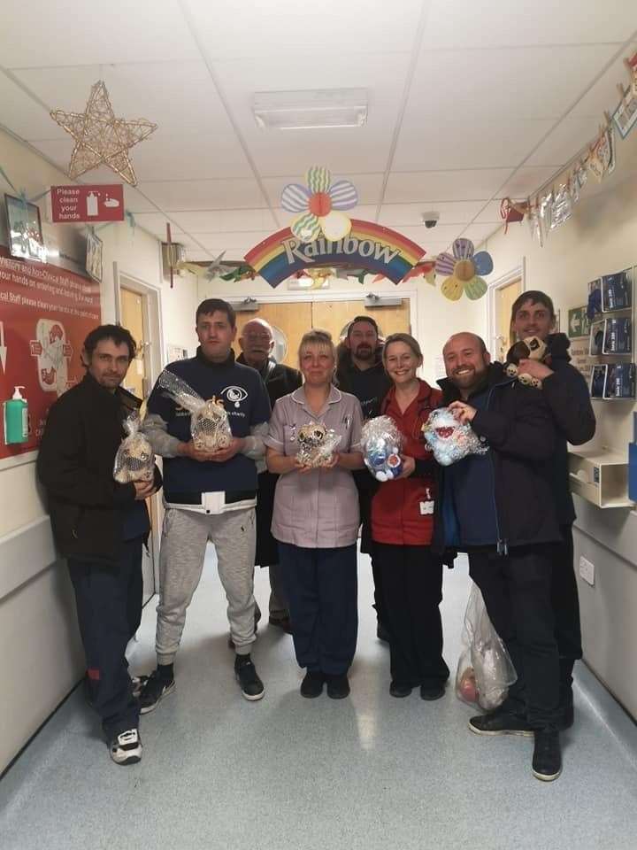 Members of SANDS United FC hand over teddie bears to Rainbow Ward staff at the QEQM in Margate