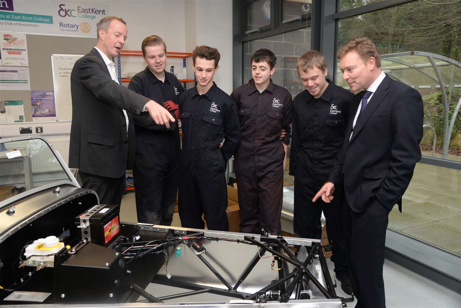 Education minister Nick Boles (left) and prospective parliamentary candidate Craig Mackinlay (right) with students working on the Caterham car at East Kent College.