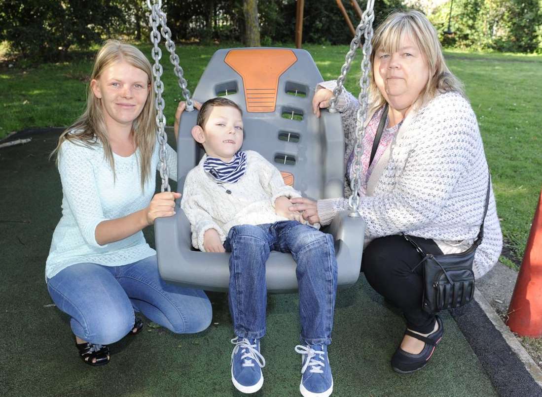 Six-year-old Sean Munday with mum Naomi (right) and Linda Munday, pictured when the swing was installed