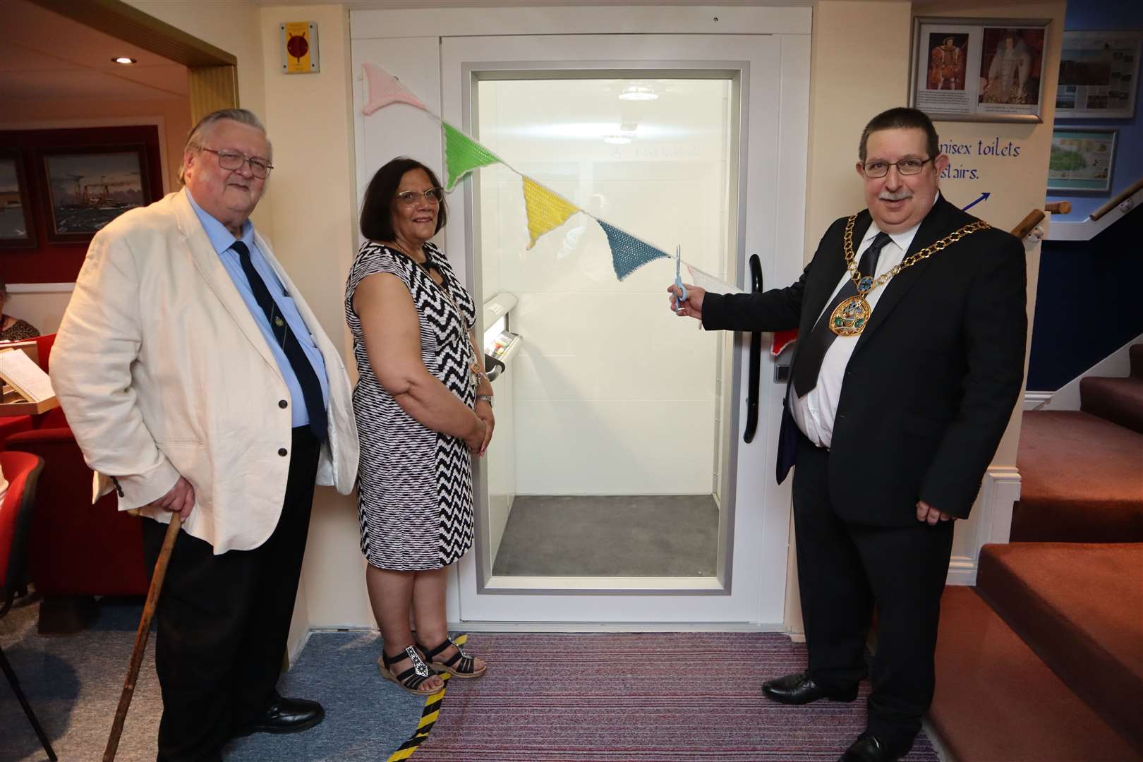 Ken Ingleton and Jenny Hurkett watch as Swale mayor Cllr Simon Clark cuts the bunting to officially open the new lift at the Criterion Theatre