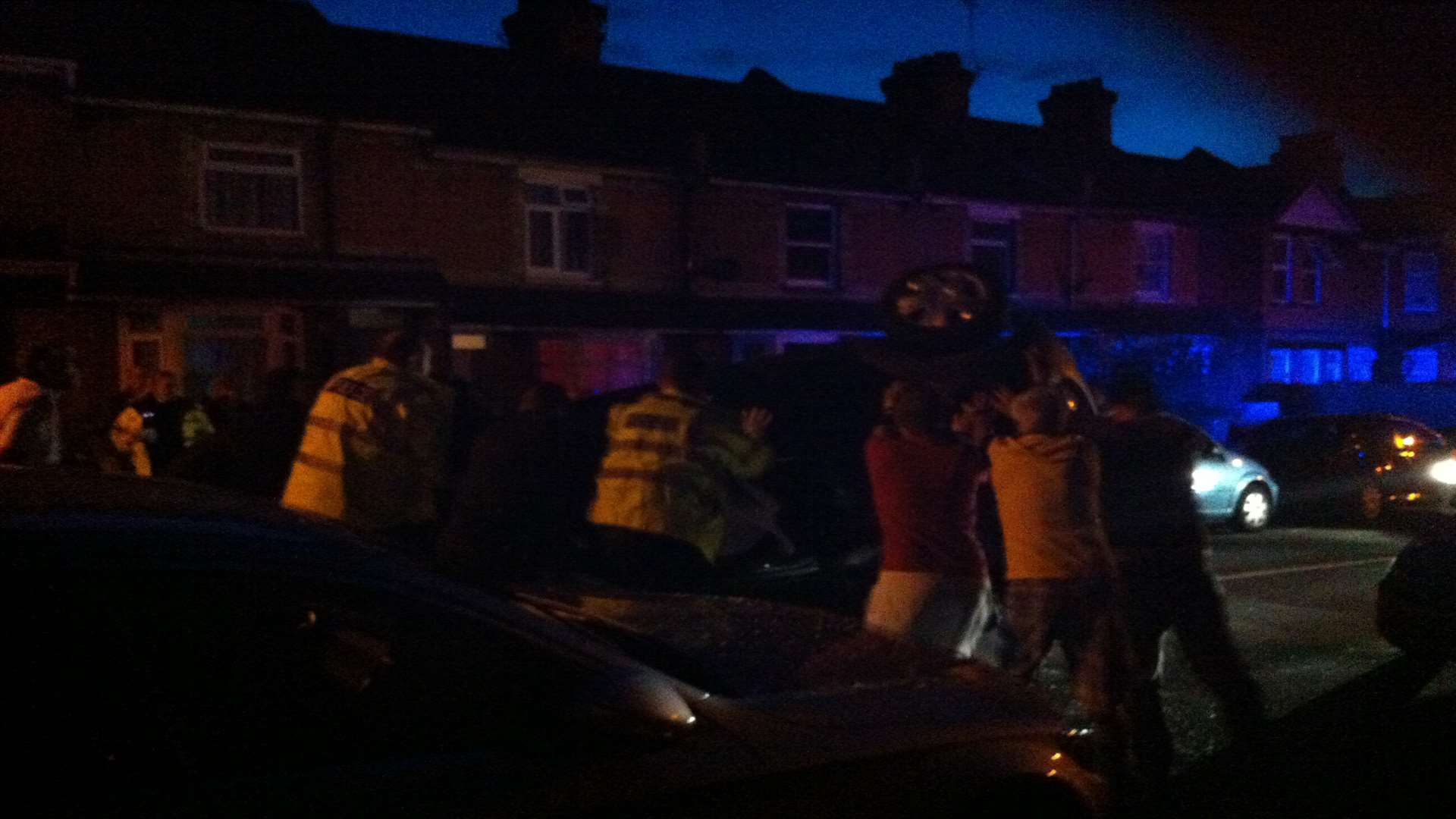 Police and residents turn the car over