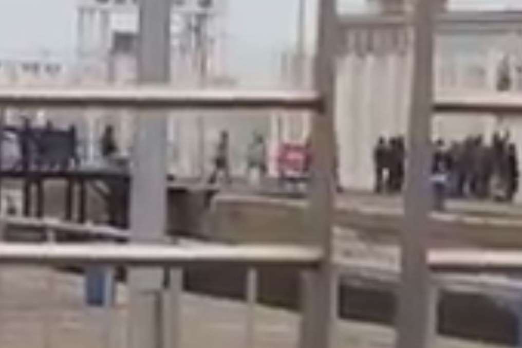 Migrants breach Calais dock fences and run into the port
