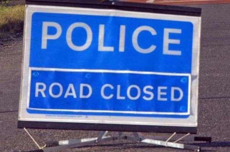 A road has been closed after a crash between a car and a van