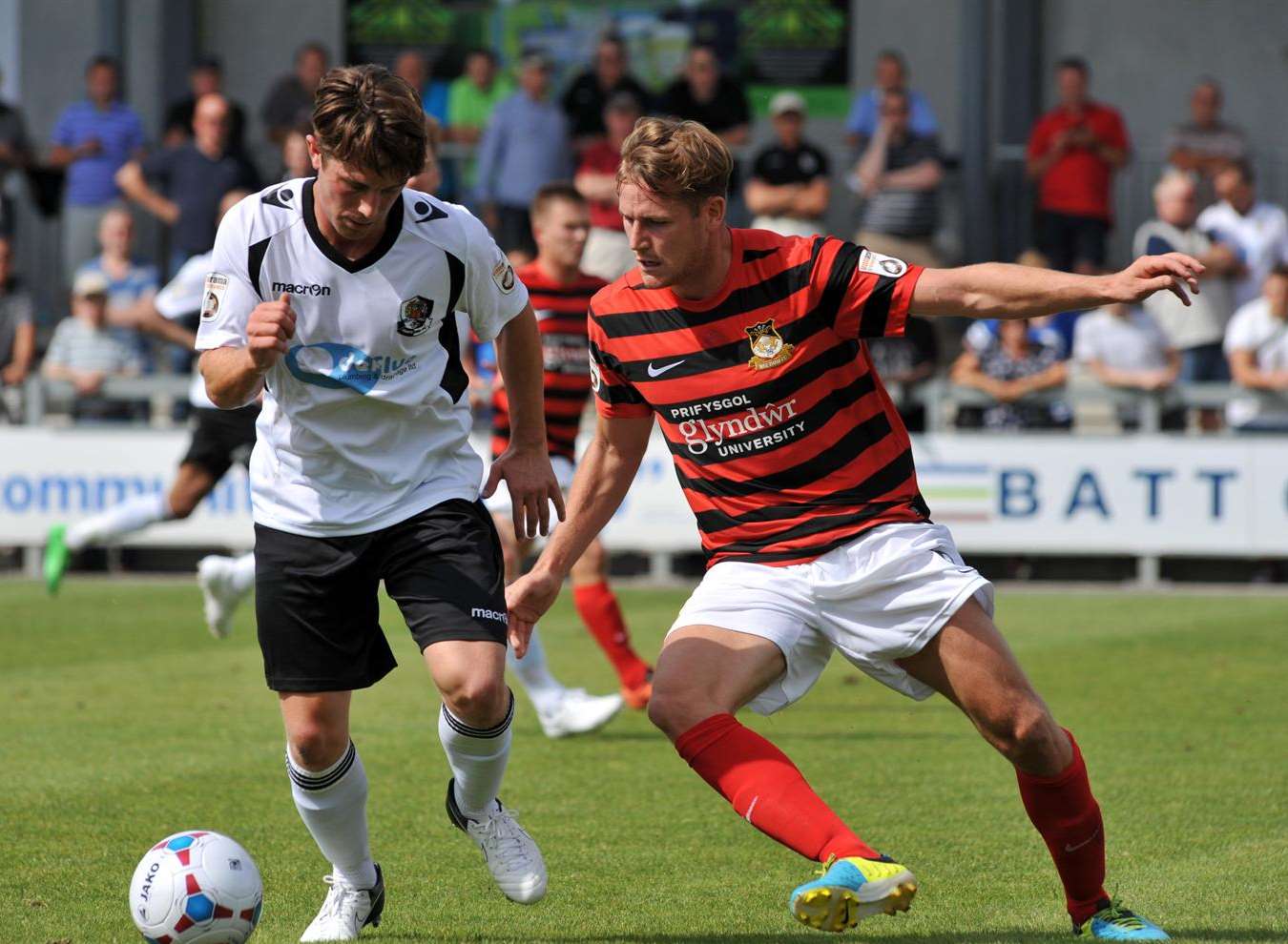 Lee Noble shields the ball from Wrexham midfielder Joe Clarke Picture: Richard Eaton