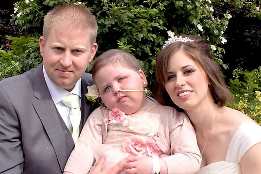 Poorly Rosie Staunton on the day her wish came true and she was a bridesmaid for her parents Laura and Ryan. Tailored Images / SWNS