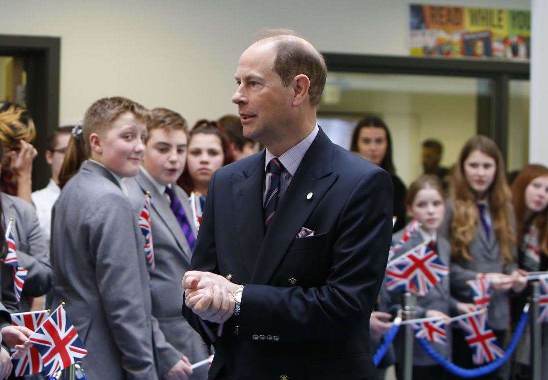 Flag-waving pupils greet the Prince