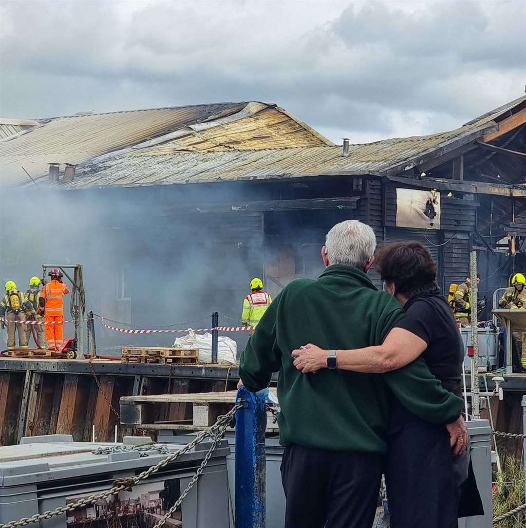 Crab and Winkle Restaurant owners Peter and Elizabeth Bennett as they watch the cockle shed fire in Whitstable Harbor engulf their business.  Image: Charlotte Rose Nash