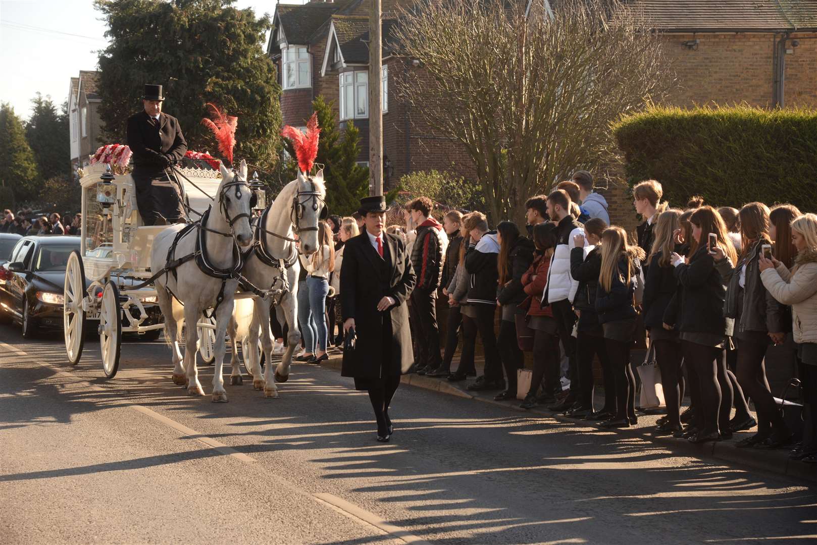 A horse drawn white carriage passed people who had gathered with balloons. Picture: Chris Davey