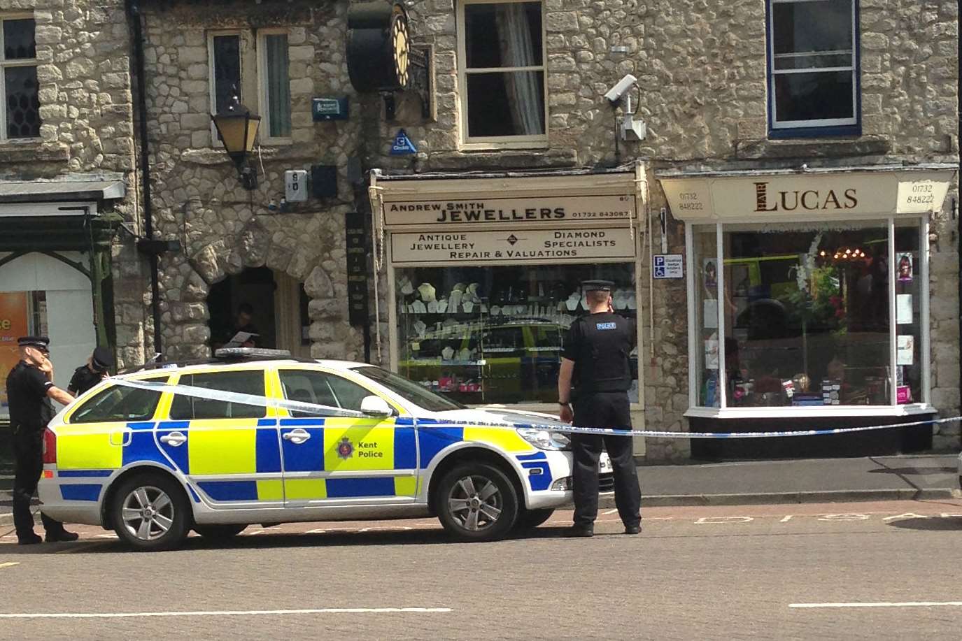 Officers surround the West Malling jewellers after a raid