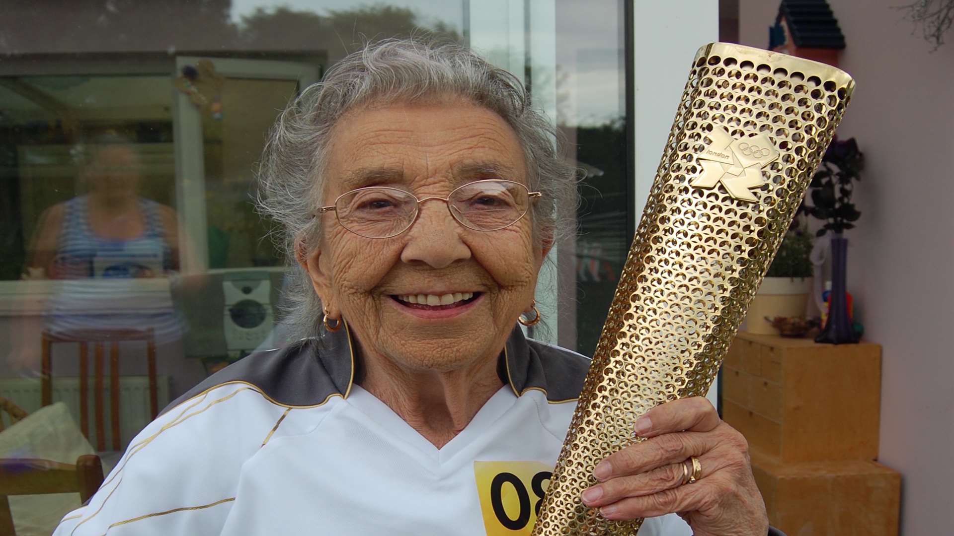 Paddy proudly holding the Olympic Torch in 2012